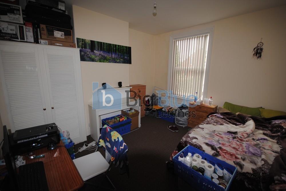 Cozy bedroom with a single bed, featuring a win...