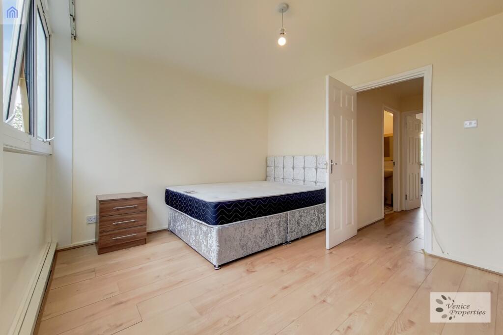 Bright and welcoming master bedroom featuring a...