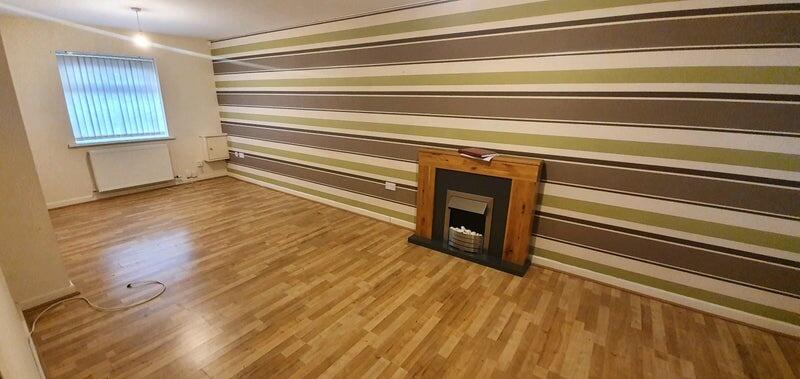 Spacious and well-maintained living room with a...