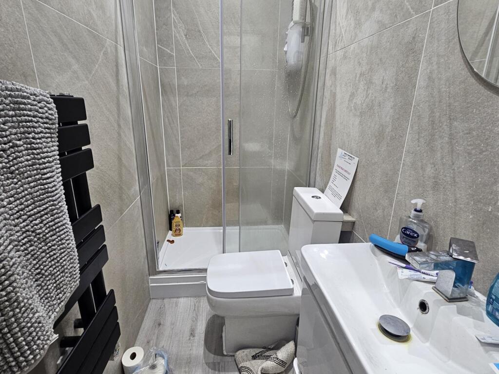 A modern, well-maintained bathroom with a large...