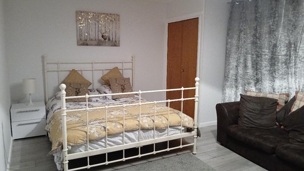 Bedroom with king-size bed and sofa