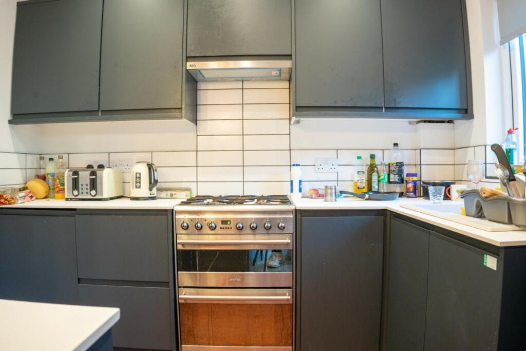A modern kitchenette with ample storage and nat...