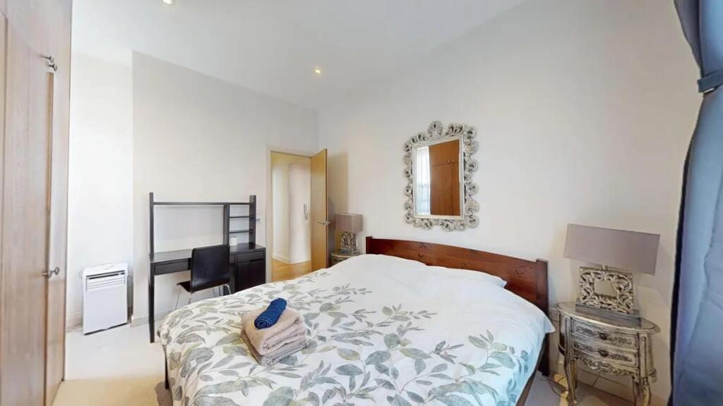A bright and inviting double bedroom featuring ...