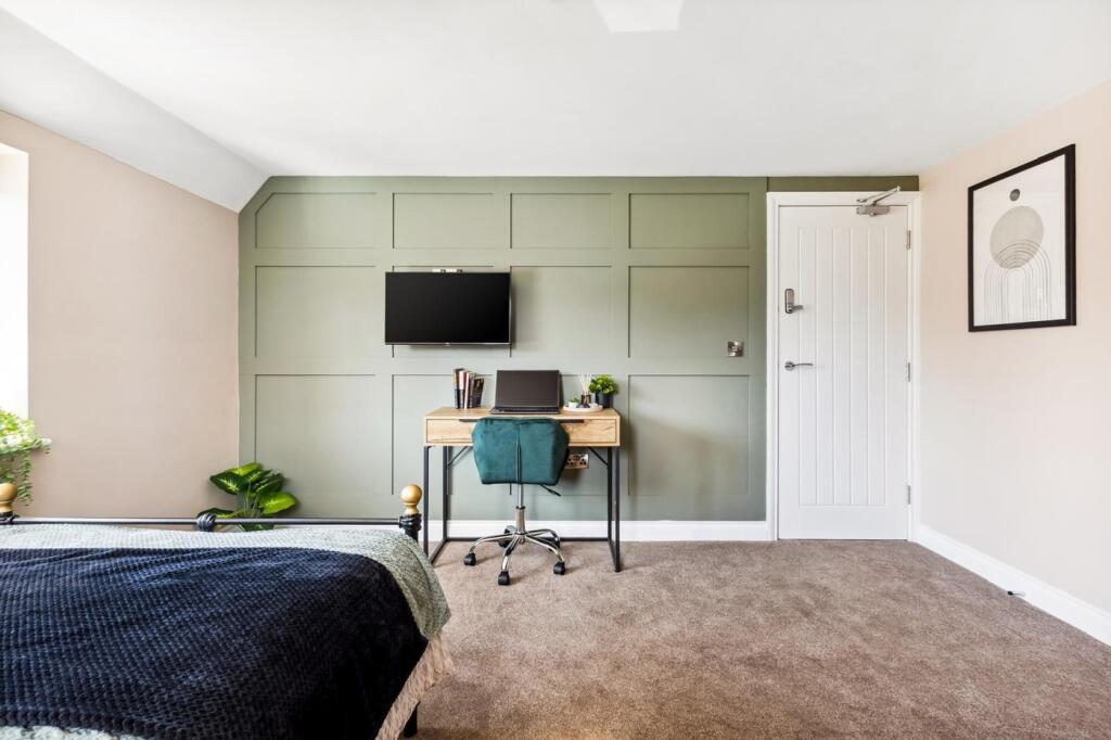 Stylish double bedroom featuring a cozy ambianc...