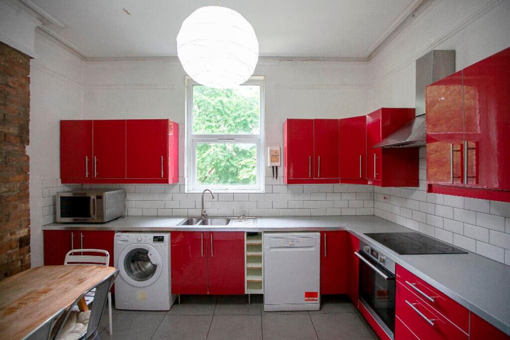 A bright and modern kitchen featuring vibrant r...