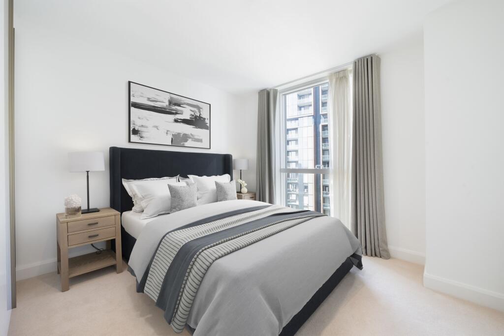 Relax in this elegant bedroom, featuring contemporary decor and urban views.