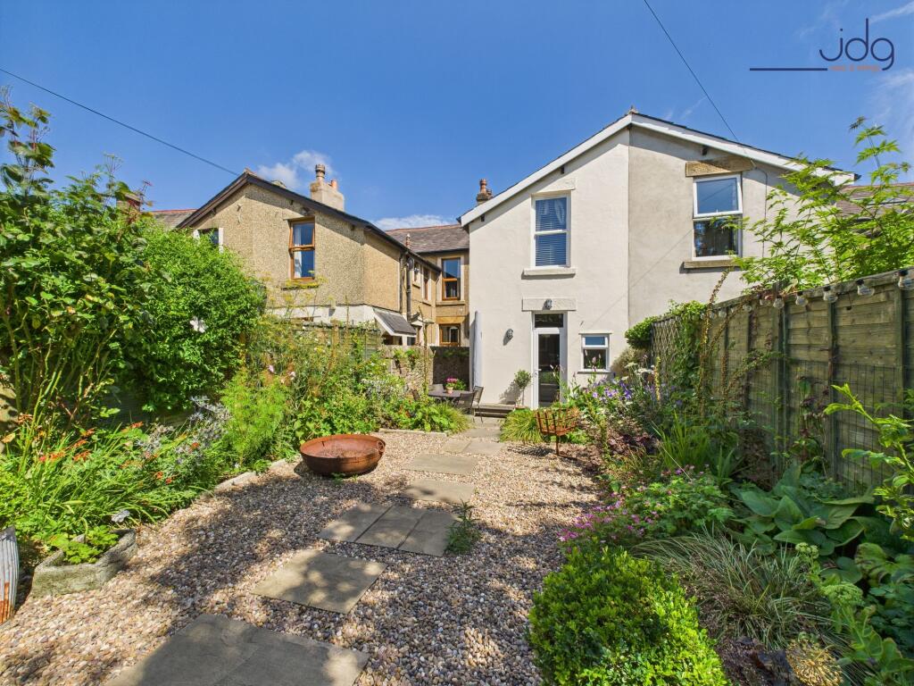 Rear view of the property and garden