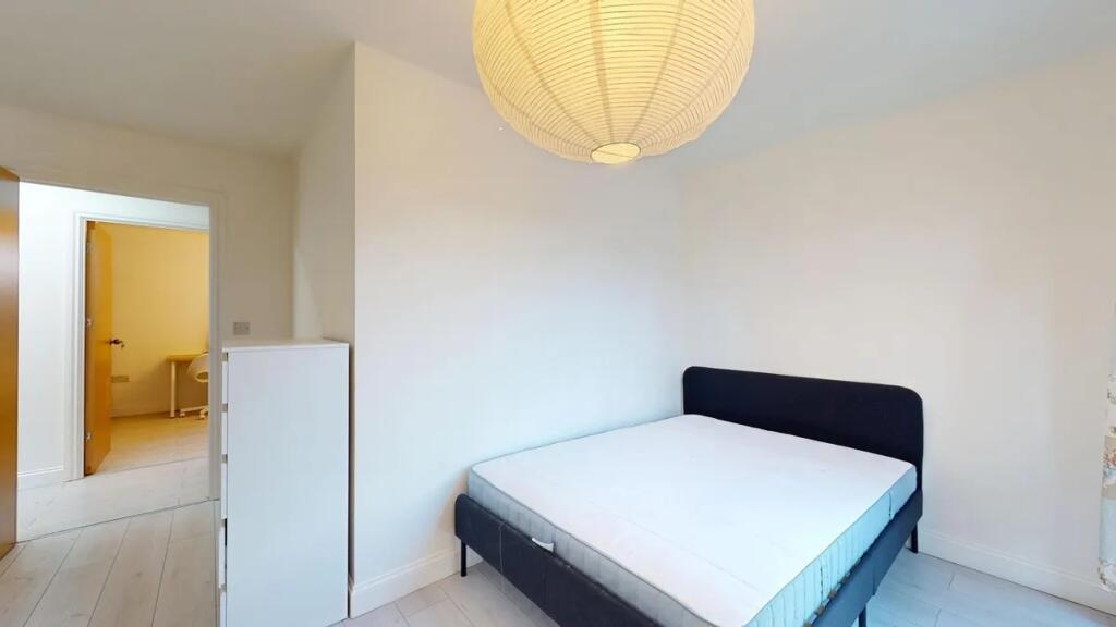 A neat and bright double bedroom featuring a co...