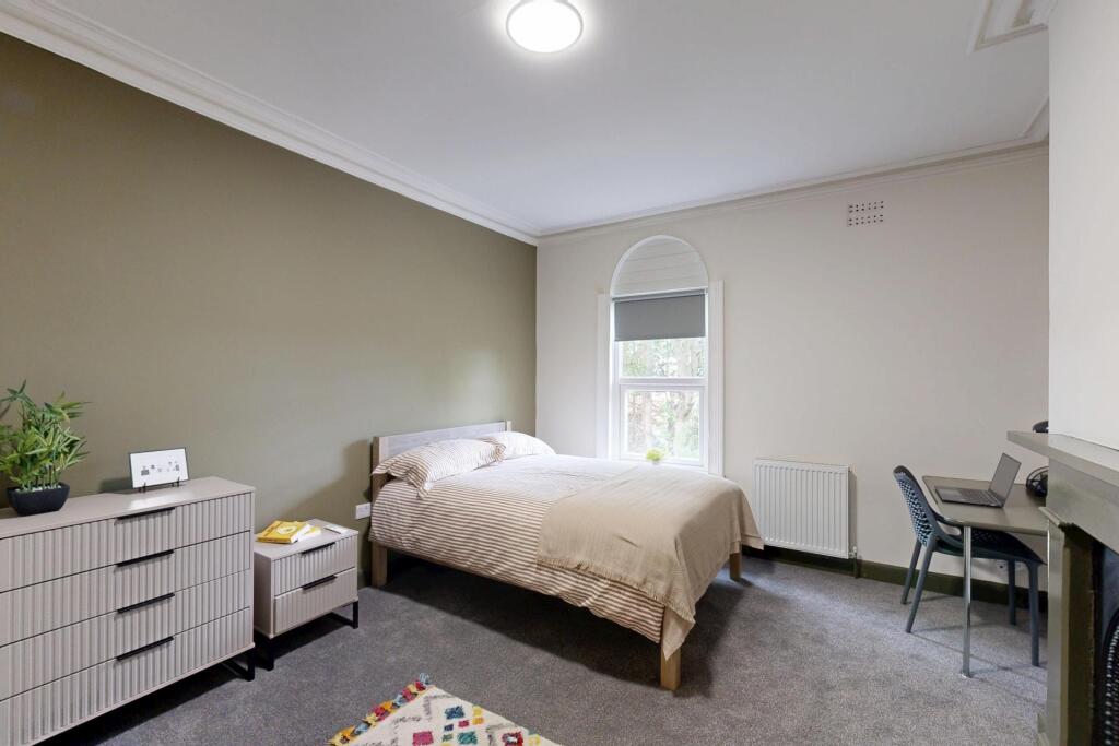 A spacious and bright master bedroom featuring ...