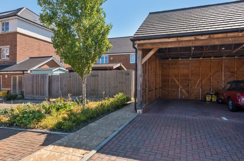 Large lit carport with gated access to garden