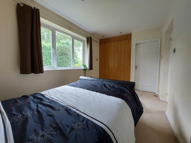 A cozy double bedroom featuring a comfortable d...