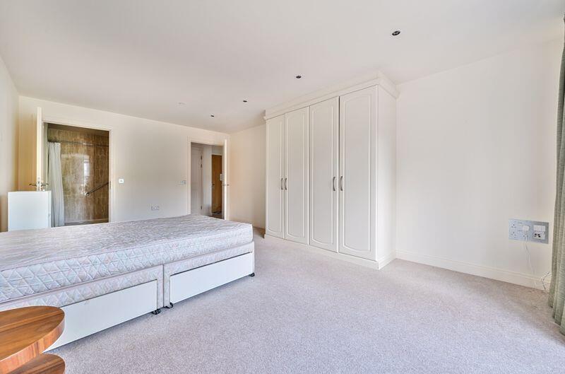 Bedroom with fitted wardrobes and ens...