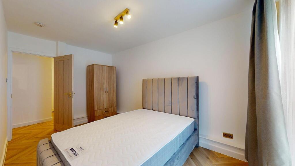 A neat and modern double bedroom featuring a pl...
