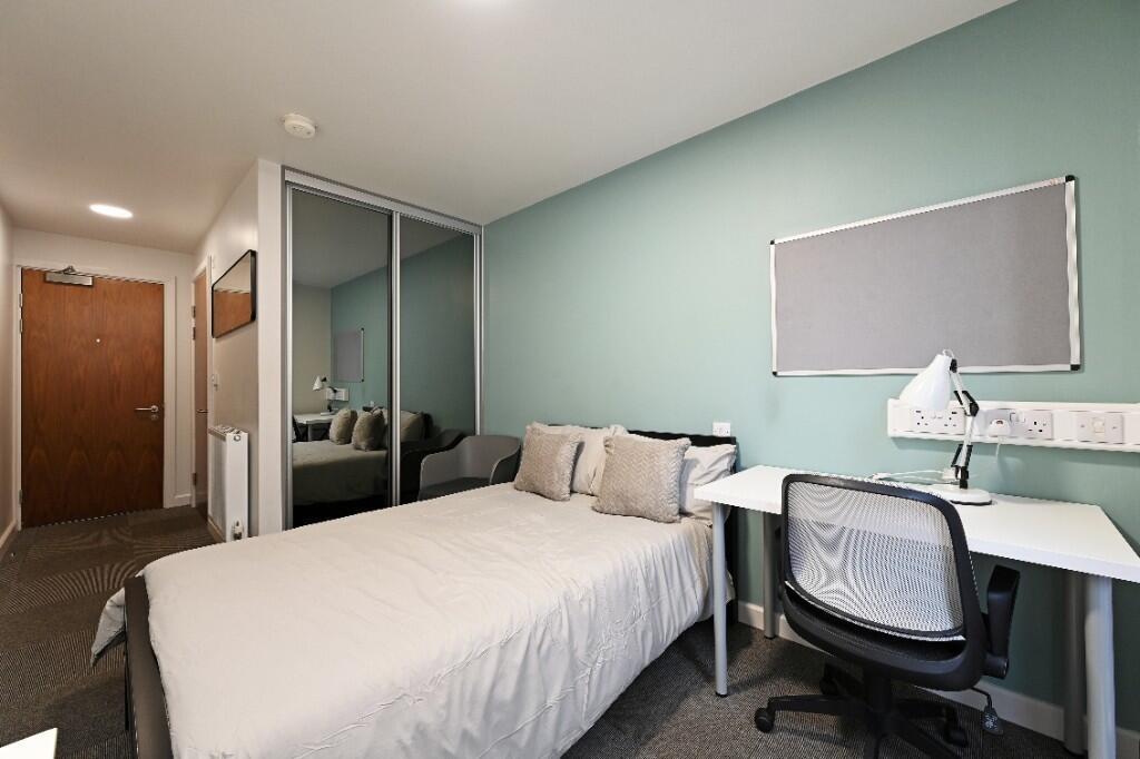 A cozy and well-maintained bedroom featuring a ...