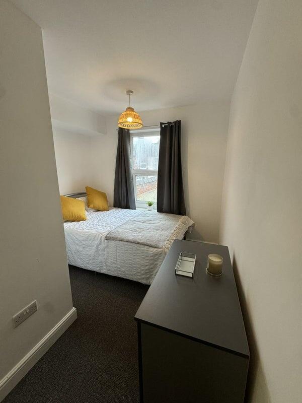 Bright and cozy double bedroom featuring a comf...