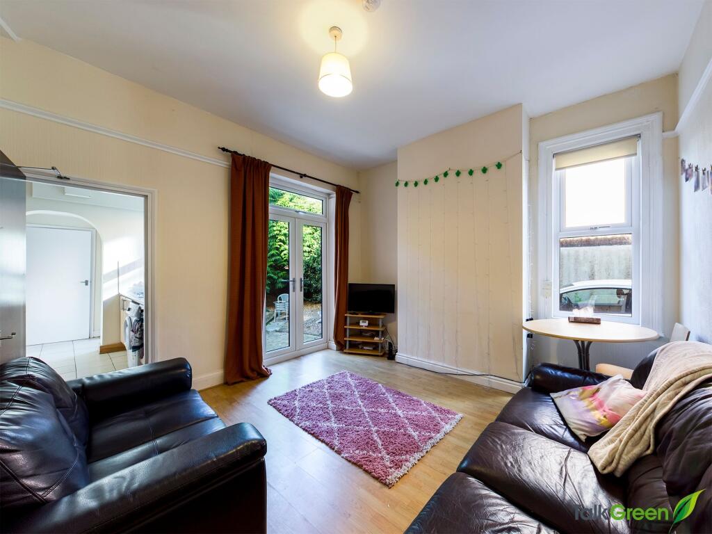 Bright and welcoming living room with ample nat...