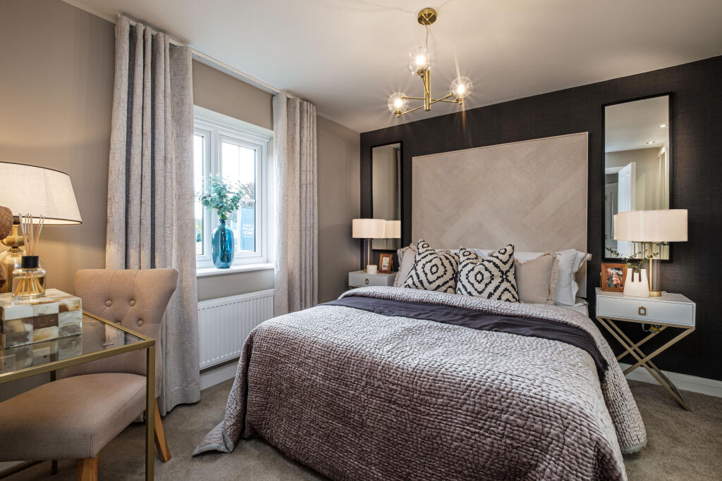 Double bedroom with oversized headboard and grey bedding