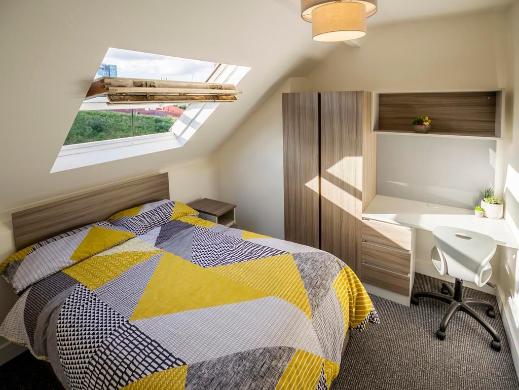 Cozy double bedroom featuring a comfortable bed...