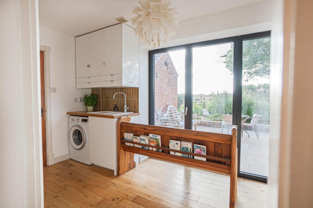 Handy utility with bi-fold doors direct onto the garden