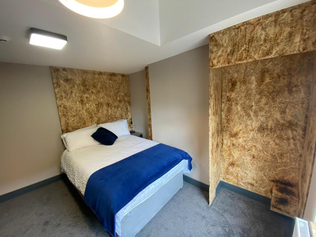 A welcoming double bedroom featuring a comforta...