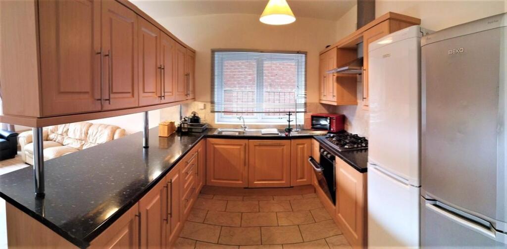 A spacious and well-maintained kitchen featurin...