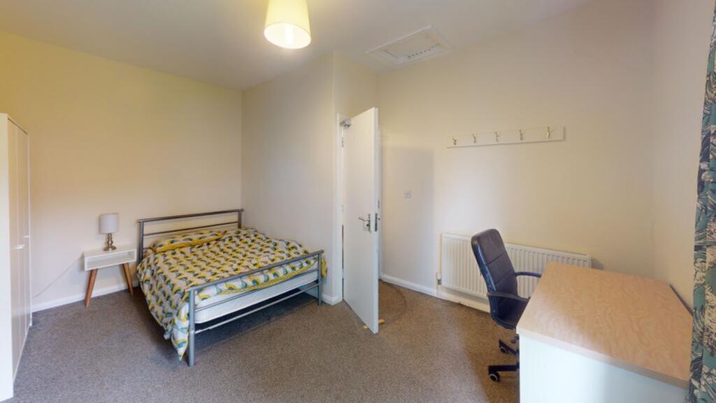 A spacious and inviting double bedroom, perfect...