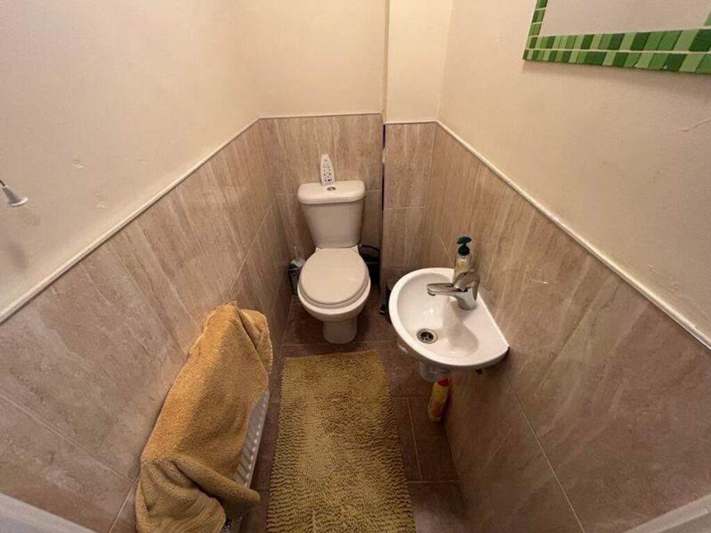 A tidy single toilet with modern fittings, prov...