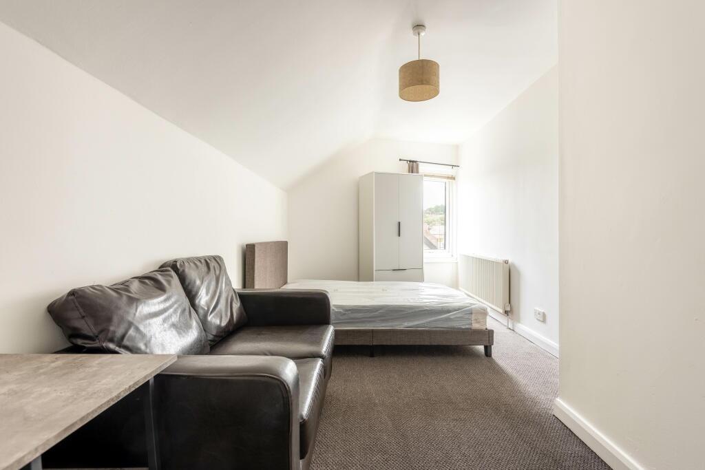 A bright and airy master bedroom featuring a co...