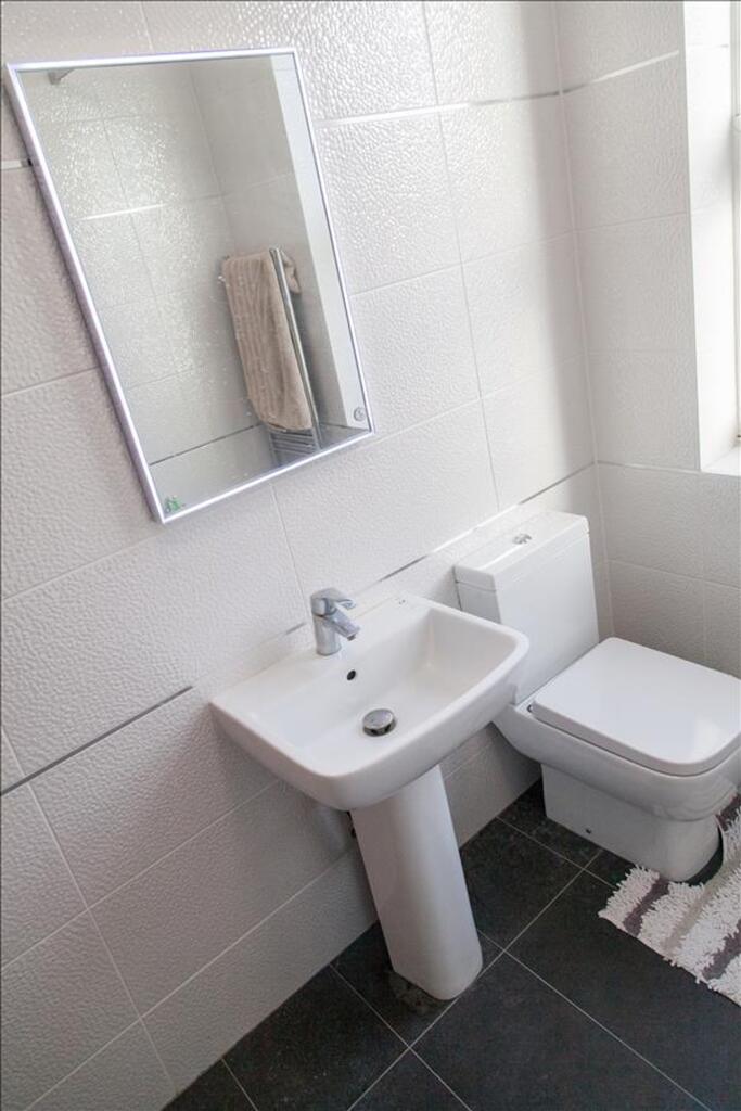 A well-maintained bathroom featuring modern fix...