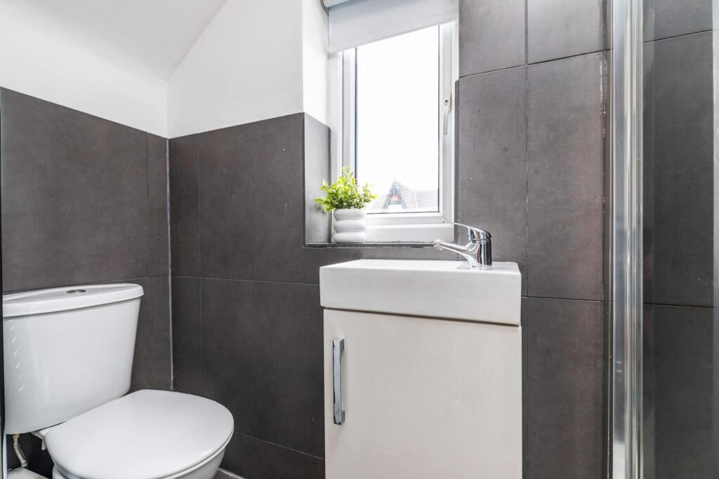 A clean, modern bathroom featuring a toilet, a ...