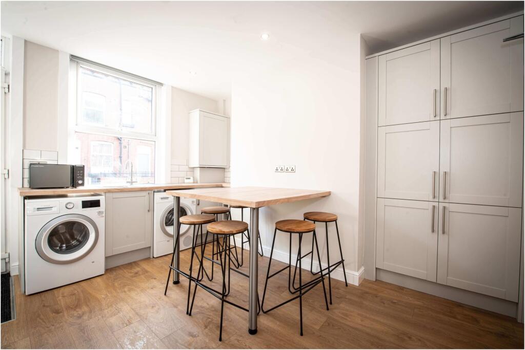 A bright and clean kitchen area with ample natu...