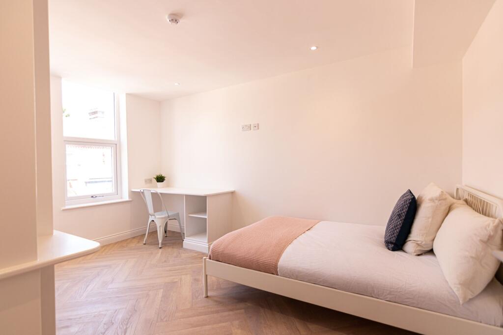 Bright and welcoming master bedroom featuring a...