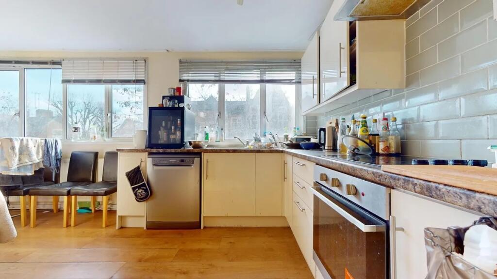 Bright and airy kitchen featuring large windows...