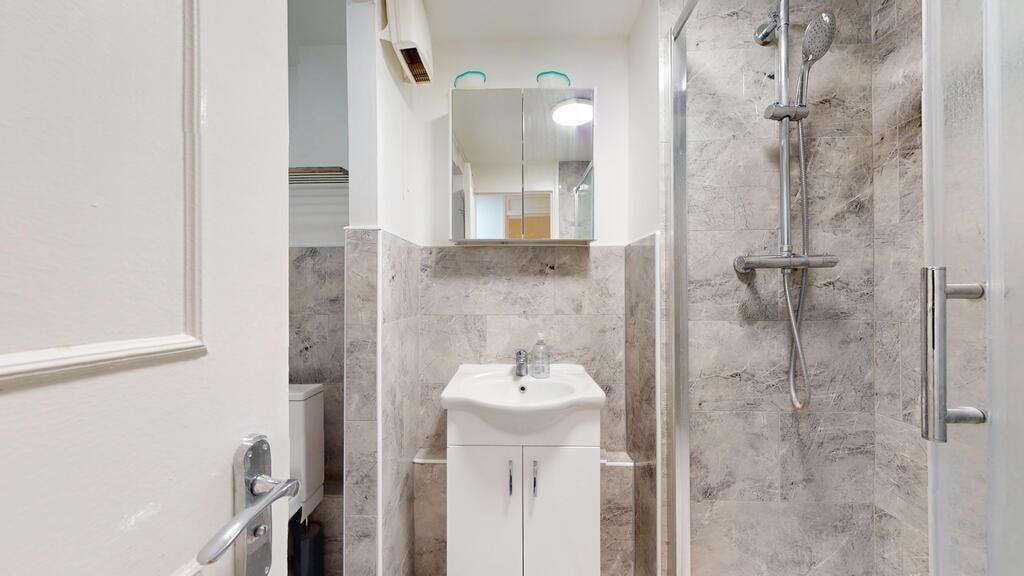 A clean and modern bathroom featuring a shower ...