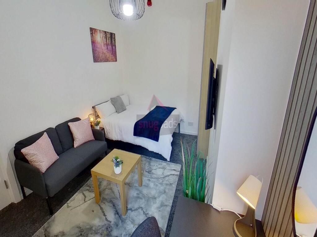 A clean and well-lit single toilet room with mo...