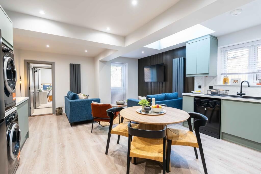 Modern and spacious living area with stylish se...