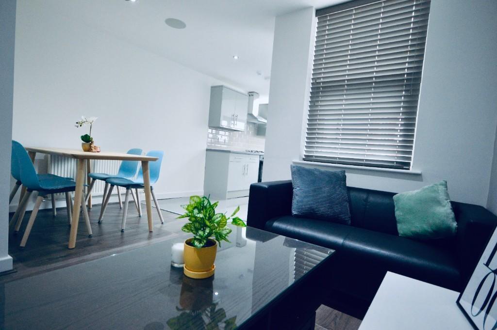 Bright and modern living room featuring a comfo...