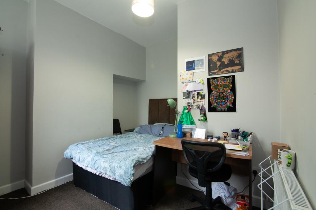 Cozy double bedroom featuring a comfortable bed...