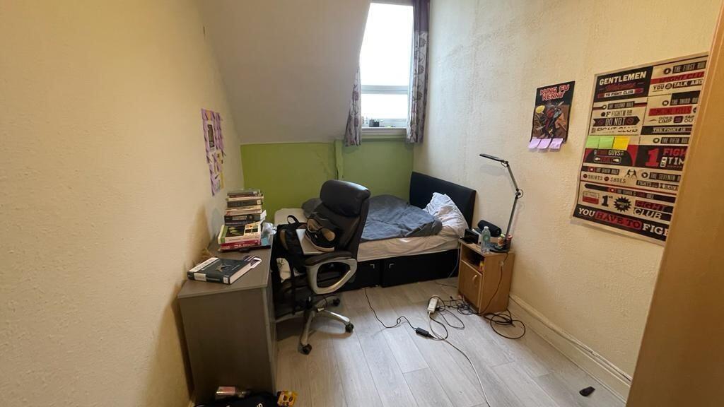 Cozy student bedroom featuring a compact layout...
