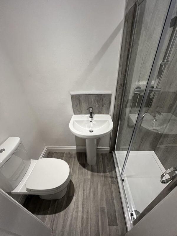 Modern bathroom featuring a sleek shower enclos...