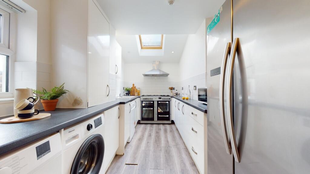 A bright and modern kitchen with ample space an...