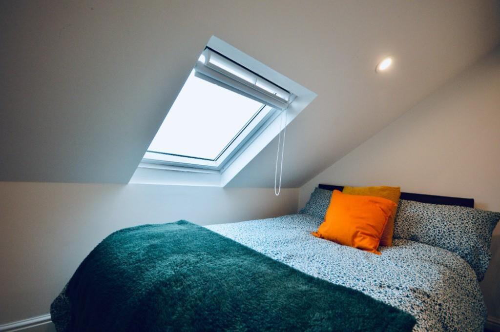 A cozy and inviting double bedroom with a styli...