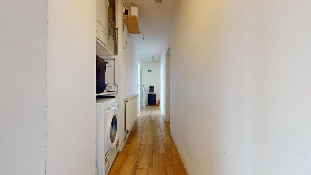 A clean and simple hallway with wooden flooring...