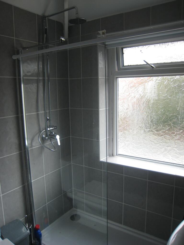 This modern bathroom features a sleek shower wi...