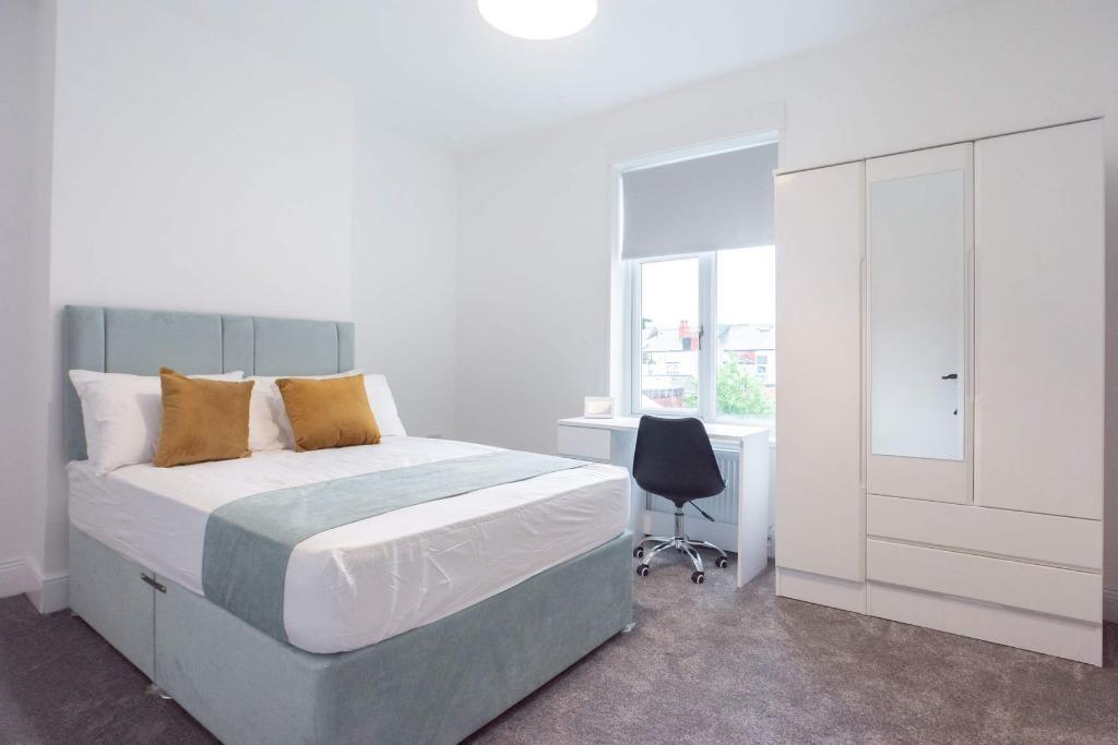 Bright and modern master bedroom featuring a co...