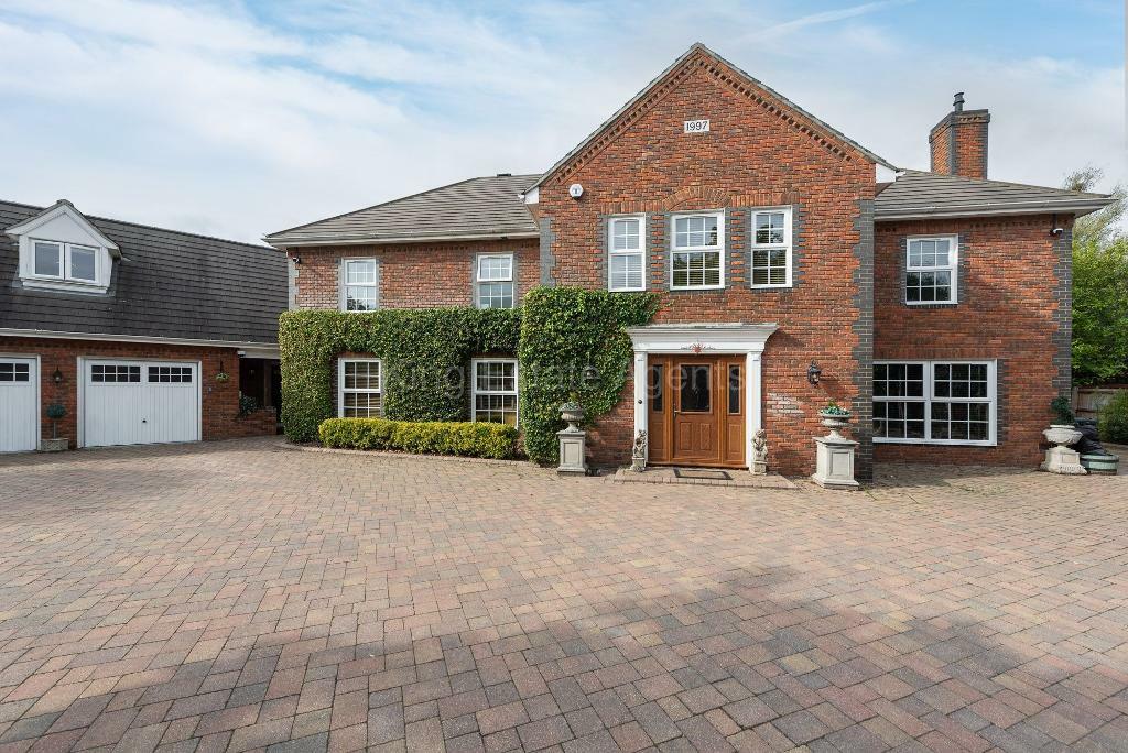 Front, triple garage and Driveway