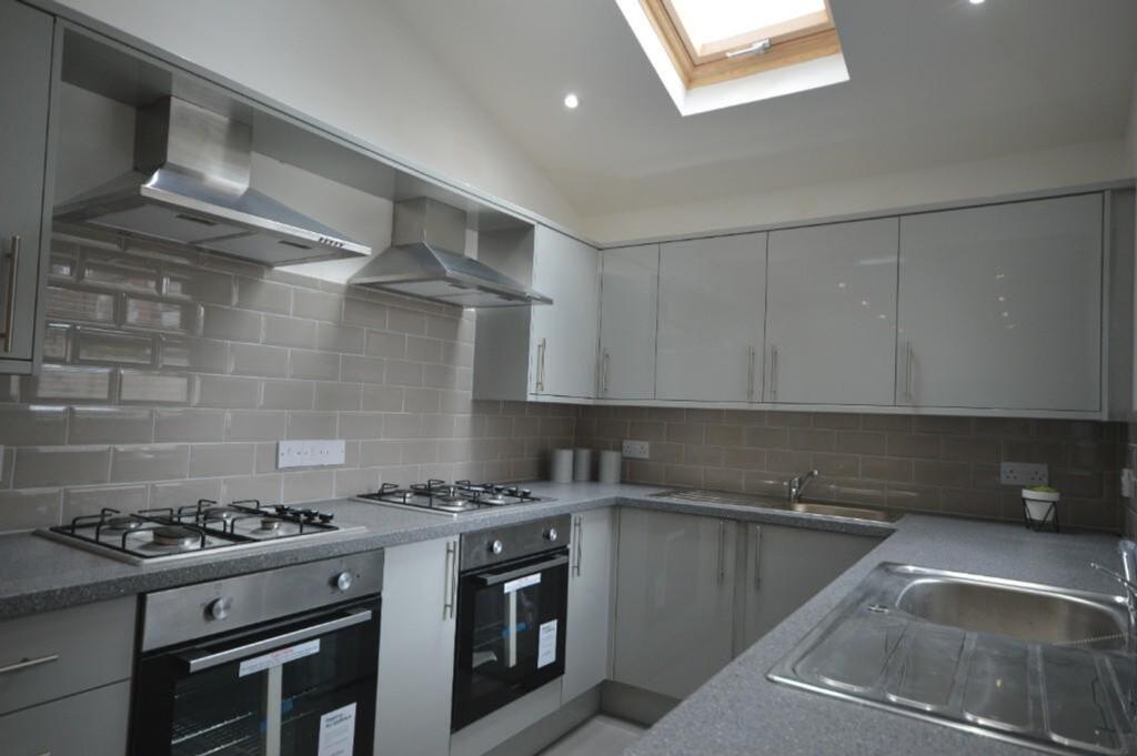 A modern kitchen featuring sleek cabinetry and ...