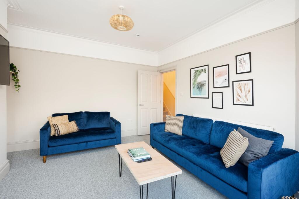 Bright, tastefully styled living room with matc...