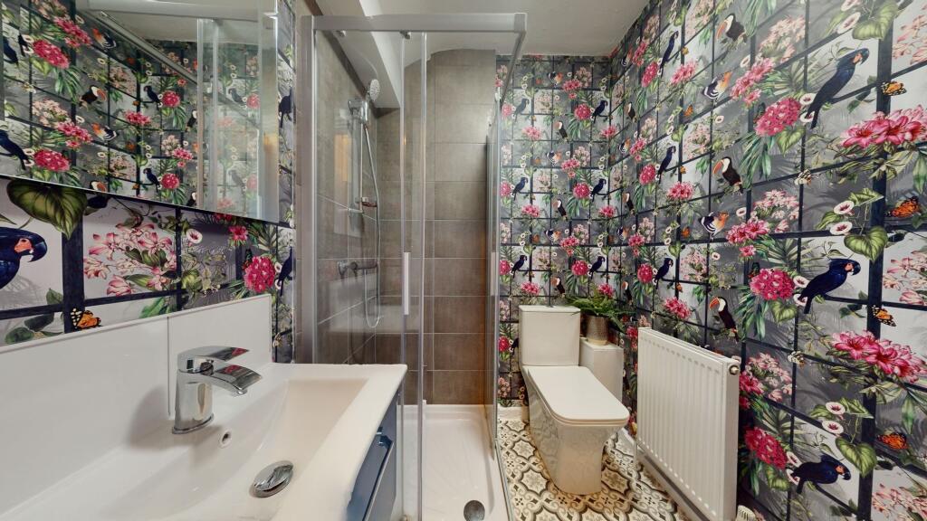 A beautifully decorated bathroom featuring vibr...