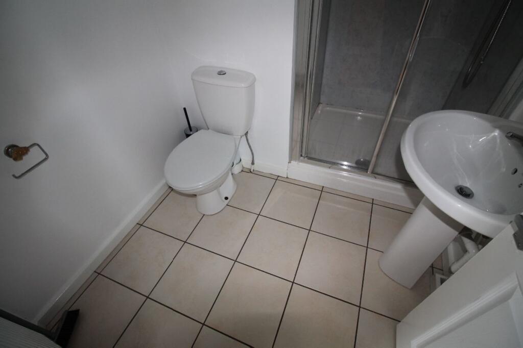 Bright and clean bathroom featuring a white toi...